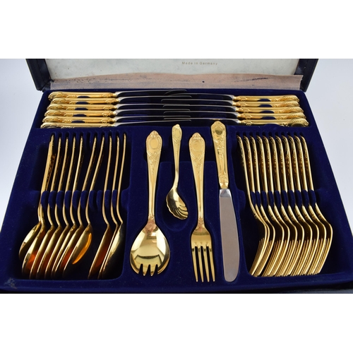 325 - A cased Solingen 24k gold plated cutlery set, in leather brief case, with 3 trays of cutlery, all in... 