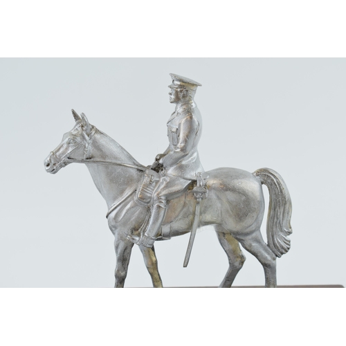 330 - A pewter military man on horse back on wooden base. Height 20cm.