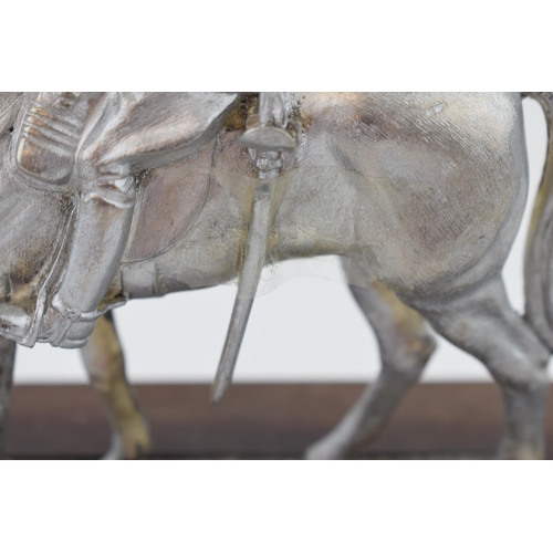 330 - A pewter military man on horse back on wooden base. Height 20cm.