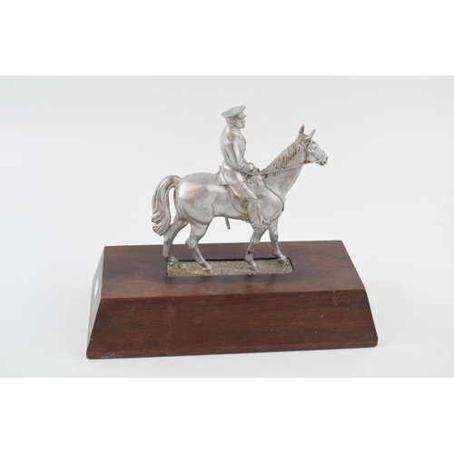 330 - A pewter military man on horse back on wooden base. Height 20cm.