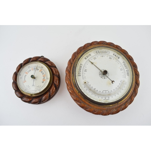 350 - A barometer with intergrated thermometer. Golden oak case. White dial with brass hand. Diameter 22cm... 