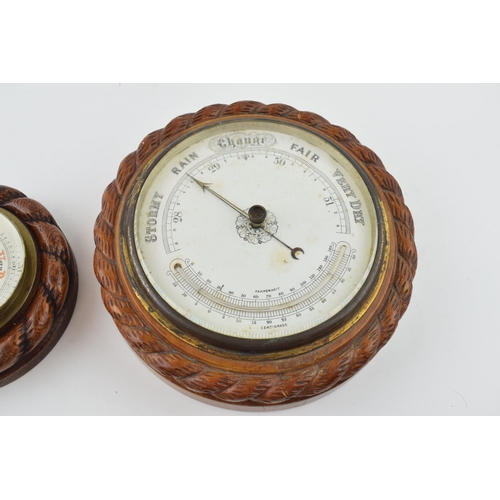 350 - A barometer with intergrated thermometer. Golden oak case. White dial with brass hand. Diameter 22cm... 