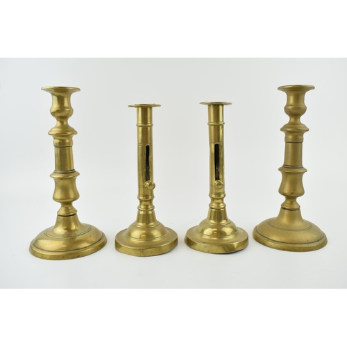 353 - Two pairs of early brass candle sticks with spun bases. One pair benefiting from having height adjus... 