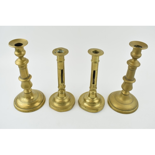 353 - Two pairs of early brass candle sticks with spun bases. One pair benefiting from having height adjus... 