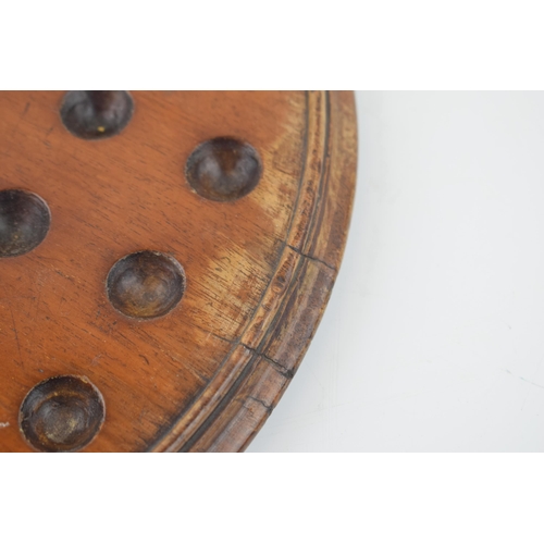 357 - An antique solitaire board with associated marbles. Diameter 30cm.