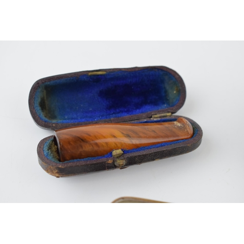 369 - A collection of items to include an
 cased amber cigar holder, paper mâché snuff box and a vesta cas... 