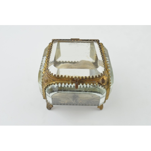 373 - A vintage Ormolu jewellery box. Heavy glass with brass frame.  inscribed to lid. Height 7.5cm.