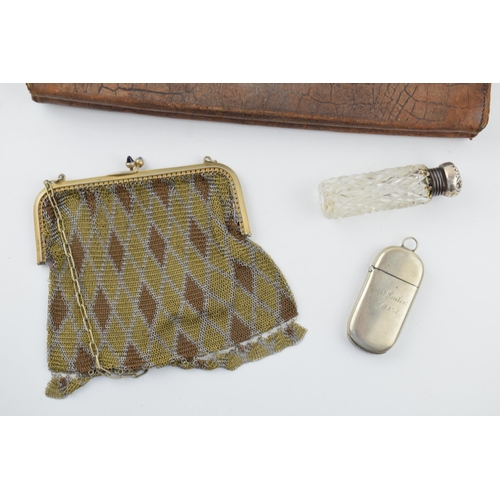 380 - A collection of items to include a crocodile skin purse, with silver clasps and mounts. A silver top... 