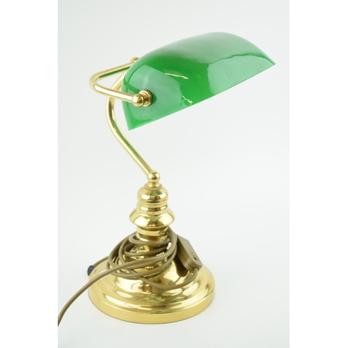 384 - A bankers lamp with brass base and green glass shade. Height 36cm.