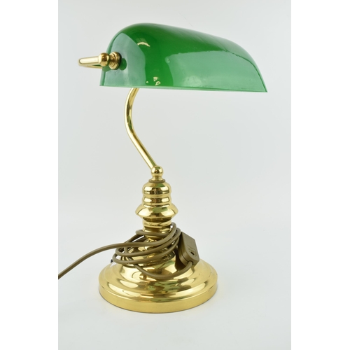 384 - A bankers lamp with brass base and green glass shade. Height 36cm.