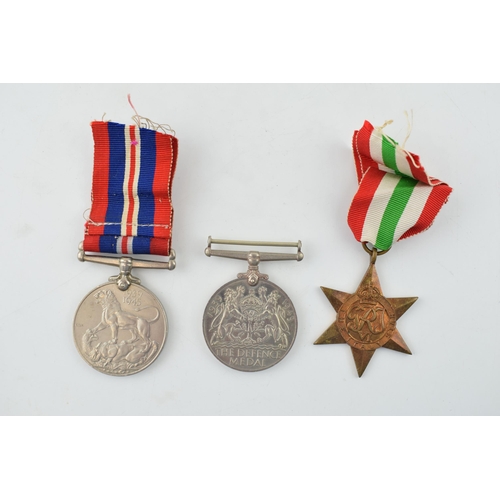 392 - A WWII War Service medal together with a Defence Medal and an Italy Star. (3)