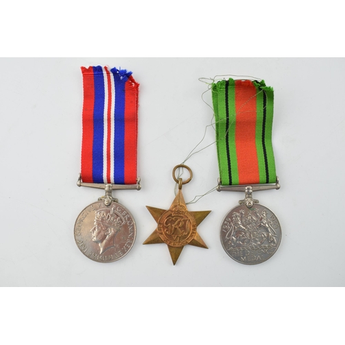 393 - A WWII War Service medal together with a Defence Medal and an Africa Star. (3)