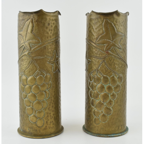 397 - A pair of Trench Art vases, 23cm tall, with grape and vine decoration, possibly 1916.