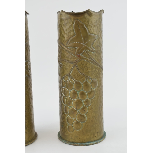 397 - A pair of Trench Art vases, 23cm tall, with grape and vine decoration, possibly 1916.