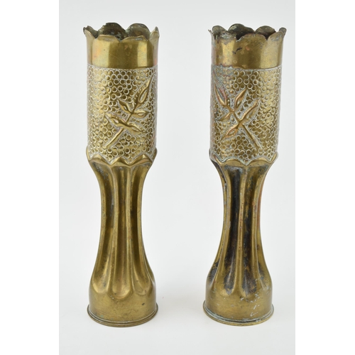 399 - A pair of Trench Art vases, 34cm tall, shaped edges, leaf decoration.