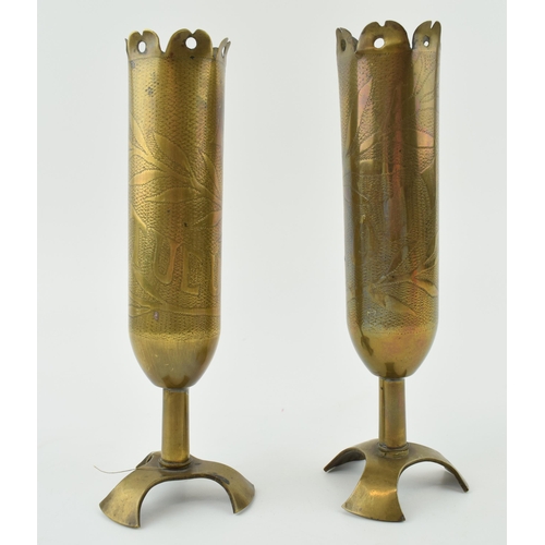 399A - A pair of trench art vases, with shaped feet, to include ‘Souvenir’ and ‘Affecteux’, 18cm tall.