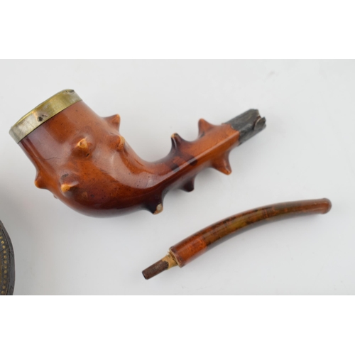 403 - A collection of smoking related items to include a Briar pipe with hallmarked silver mount and amber... 