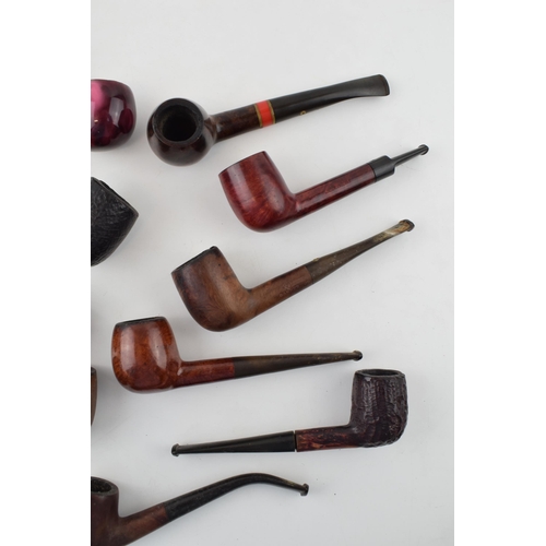 407 - A collection of vintage tobacco smoking pipes to include briar and similar examples by 'St Claude', ... 