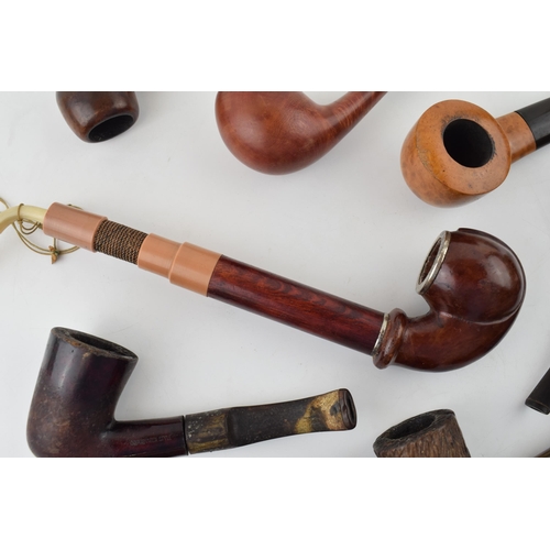 412 - A collection of vintage tobacco smoking pipes to include briar examples by 'I R Navy, 'Clifton' and ... 