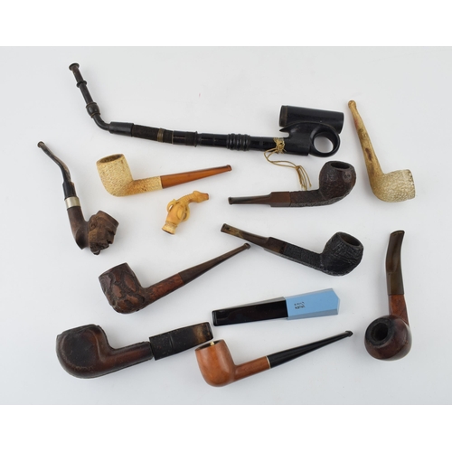 415 - An interesting collection of pipes to include clay pipes, carved wooden heads, early plastic / bakel... 