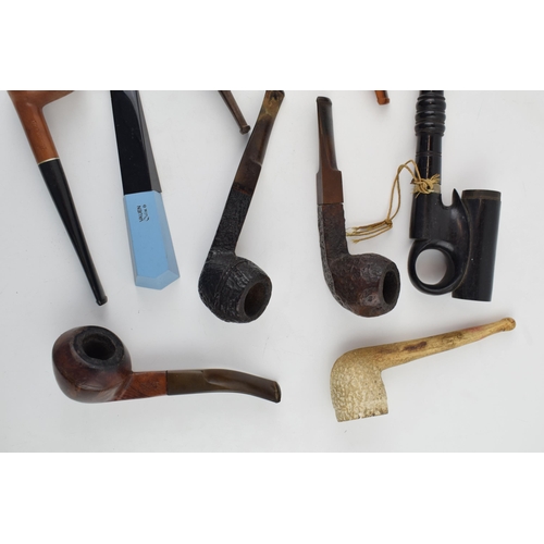 415 - An interesting collection of pipes to include clay pipes, carved wooden heads, early plastic / bakel... 