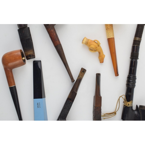 415 - An interesting collection of pipes to include clay pipes, carved wooden heads, early plastic / bakel... 