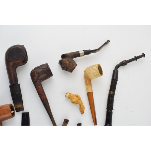 415 - An interesting collection of pipes to include clay pipes, carved wooden heads, early plastic / bakel... 