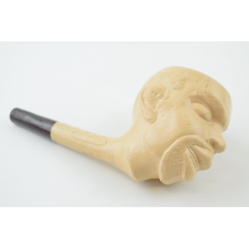 416 - A clay pipe in the form of a man's head. Length 14cm.