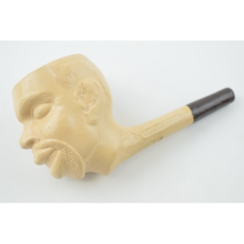 416 - A clay pipe in the form of a man's head. Length 14cm.