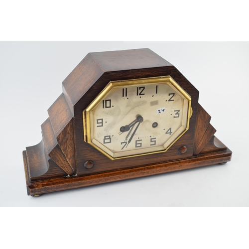 418 - An Art Deco mantle clock with chiming movement. With pendulum and key. Height 20cm.