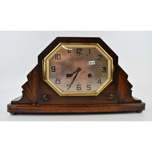 418 - An Art Deco mantle clock with chiming movement. With pendulum and key. Height 20cm.