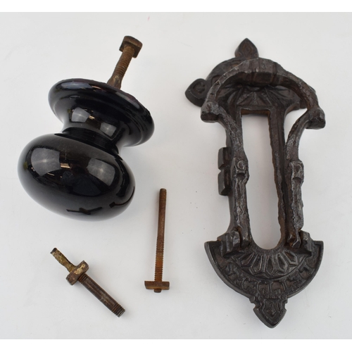 455 - A Kenrick and Sons or similar door knocker together with a ceramic Victorian door knob. (2) 23cm.