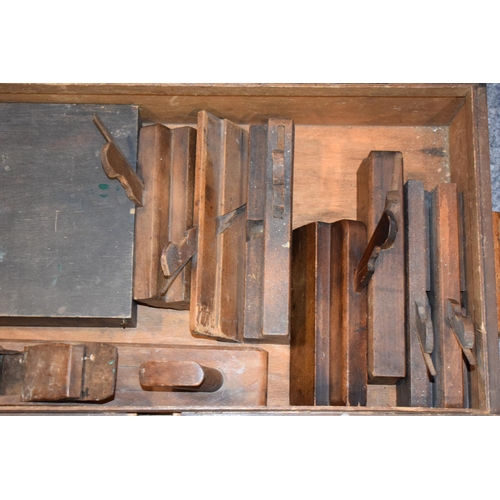 458 - A collection of wooden block planes in a vintage wooden tool chest. 66cm x 36cm x 18cm