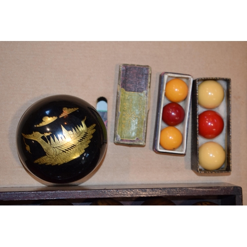 340 - A set of indoor bowls by Henry A. Murton Ltd in lignum vitae in original box together with vintage b... 