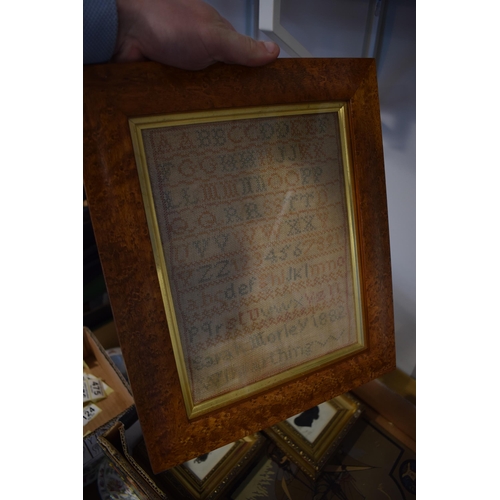 429 - A 19th century sampler dated 1882 together with a pair of silhouettes. Items are in later frames. To... 