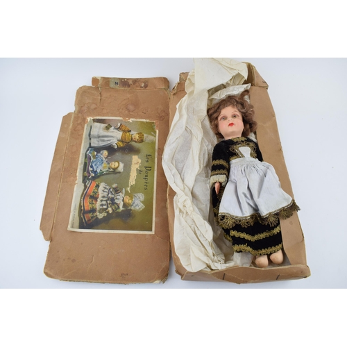 466 - Boxed 'Les Poupees' de Bretagne, papier mache dolls of Brittany. Doll height 32cm.