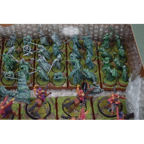 489 - A collection of cast metal and plastic war-games and miniature figures by 'Games Workshop' from the ... 