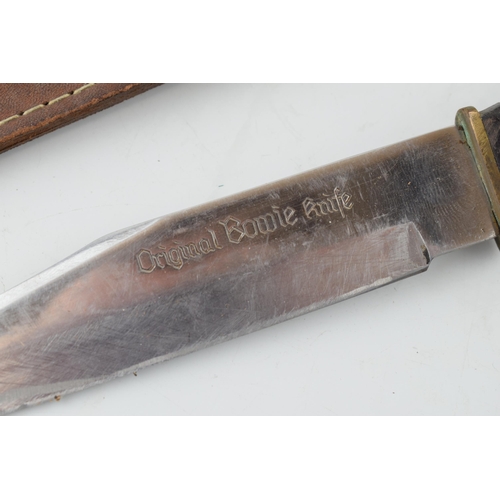 513 - Bowie knife in leather sheath, 'Made in Japan'. Lather handle, 'Stainless Steel Blade', 'Original Bo... 