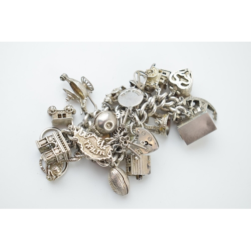 297A - Heavy silver charm bracelet to include an American football, a fish, a boat, a teapot and others, 11... 