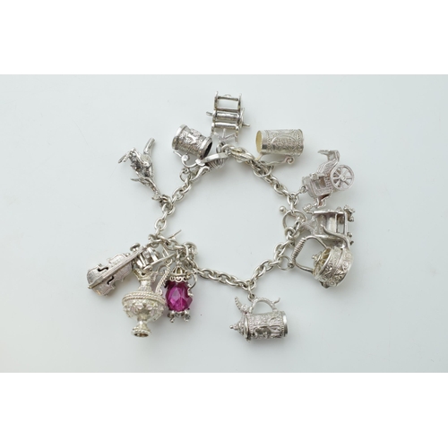 297B - Silver charm bracelet with  a teapot, a tankard, a cello, a throne and others, 65.0 grams.