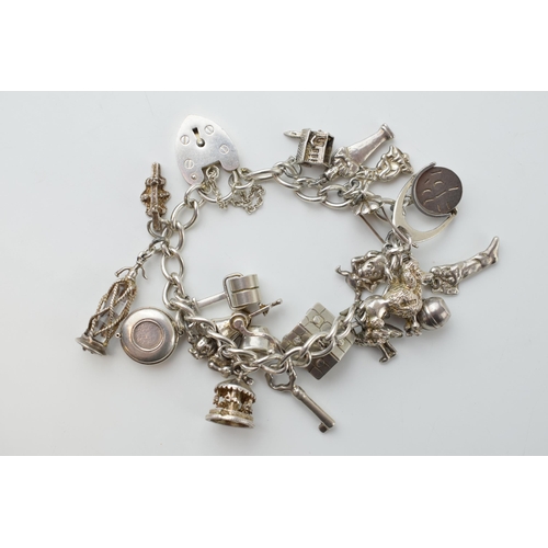 297C - Silver charm bracelet with a poodle, a chalet, a grinder, a Sodastream and others, 78.5 grams.