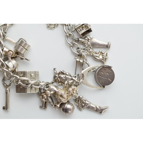 297C - Silver charm bracelet with a poodle, a chalet, a grinder, a Sodastream and others, 78.5 grams.