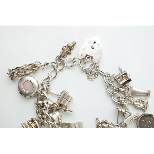 297C - Silver charm bracelet with a poodle, a chalet, a grinder, a Sodastream and others, 78.5 grams.