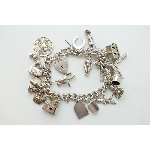 297D - Silver charm bracelet with a church, a bear, people, a tankard and others, 81.6 grams.