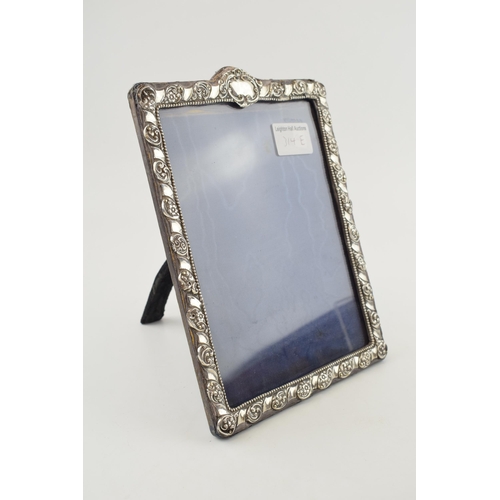 314E - Hallmarked silver photo frame, floral border, easel back, 25cm tall, Birm 1905.