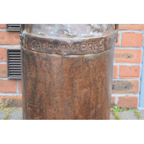 533 - Cadbury Bros Ltd cast metal milk burn with lid, also stamped Cadbury, 73cm tall, with two handles.