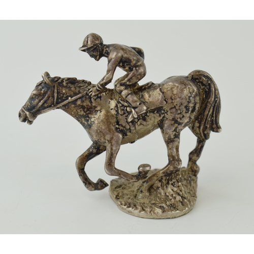 568 - Silver model of a horse and rider, 58mm long, 74.4 grams.