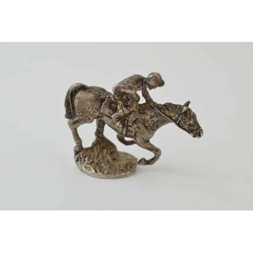 568 - Silver model of a horse and rider, 58mm long, 74.4 grams.