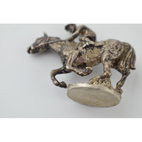 568 - Silver model of a horse and rider, 58mm long, 74.4 grams.