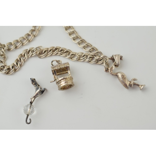 569 - A silver charm bracelet with two charms and padlock together with another four loose charms. 17.2 gr... 